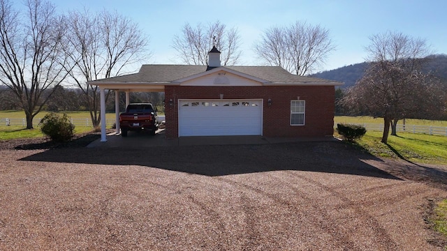 garage with a carport and a mountain view