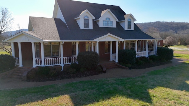 view of front of house featuring a porch and a front yard