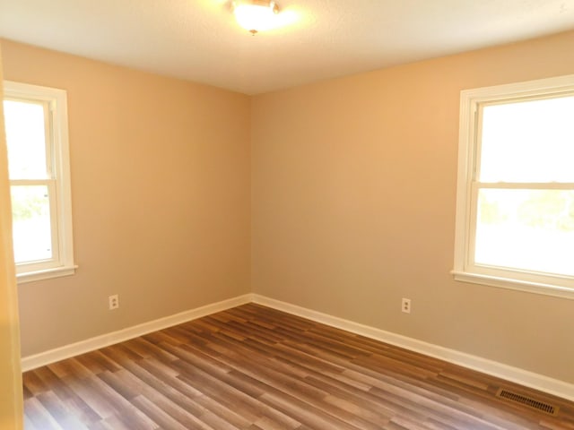 unfurnished room with hardwood / wood-style floors