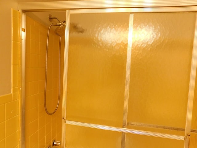 bathroom featuring a shower with shower door