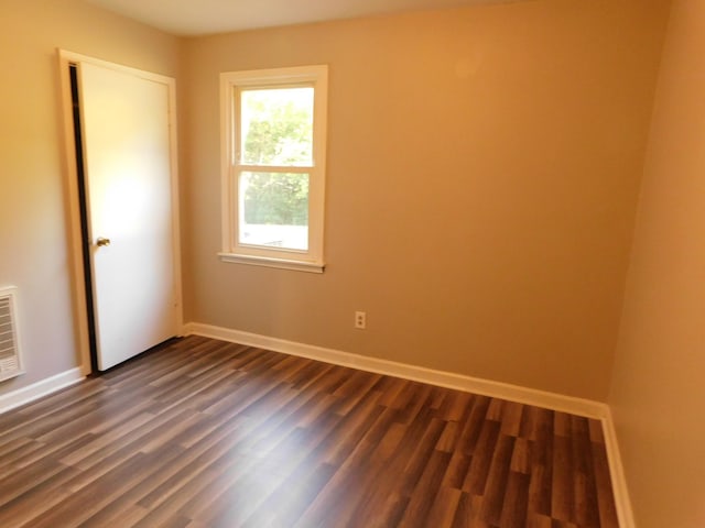 spare room featuring dark hardwood / wood-style flooring