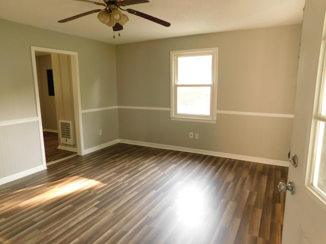 unfurnished room with ceiling fan and dark wood-type flooring