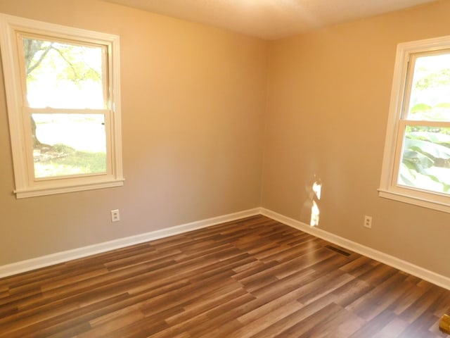 unfurnished room with dark hardwood / wood-style floors