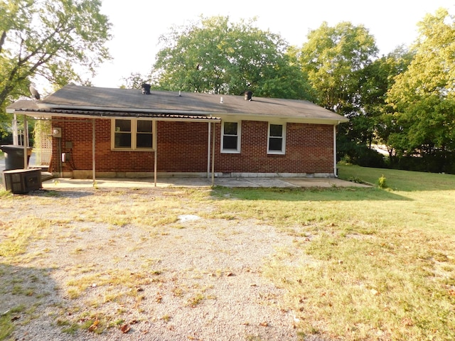 back of property featuring a yard and a patio area