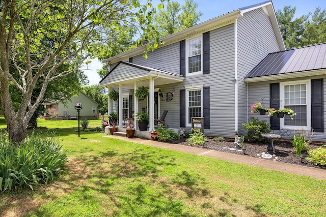 view of front facade with covered porch and a front yard