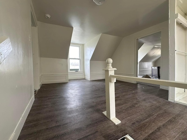 additional living space featuring dark hardwood / wood-style flooring and lofted ceiling