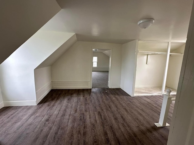 bonus room featuring lofted ceiling and dark hardwood / wood-style floors