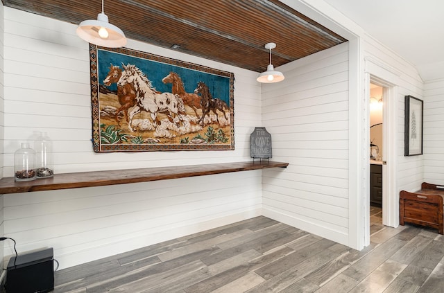 room details featuring hardwood / wood-style floors, wooden walls, and wooden ceiling