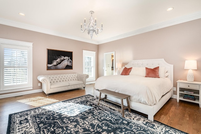 bedroom featuring wood-type flooring, an inviting chandelier, multiple windows, and ornamental molding