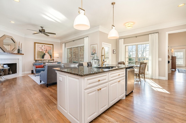 kitchen with white cabinetry, dishwasher, ceiling fan, pendant lighting, and a kitchen island