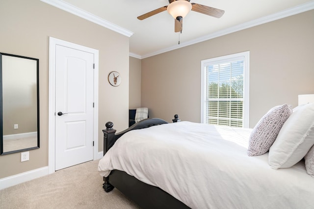 carpeted bedroom with ceiling fan and ornamental molding