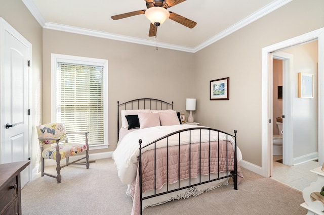 carpeted bedroom featuring ceiling fan, crown molding, and ensuite bathroom