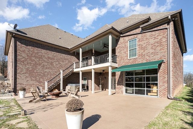 rear view of property featuring a patio, a balcony, a fire pit, and ceiling fan