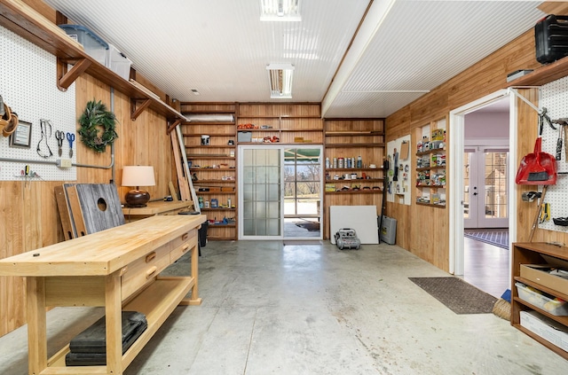 interior space with a workshop area and wooden walls