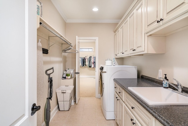 washroom with cabinets, crown molding, sink, light tile patterned floors, and separate washer and dryer