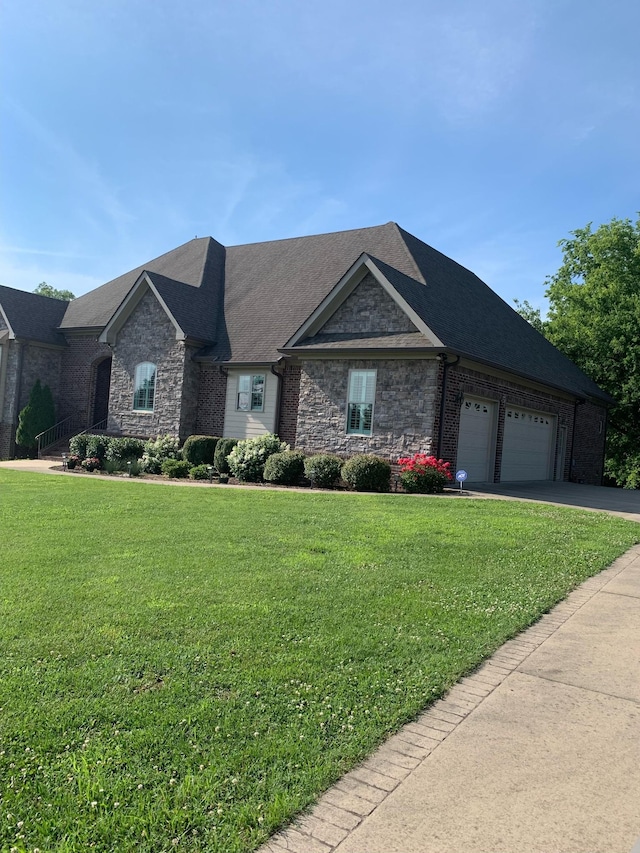 view of front of house with a garage and a front yard