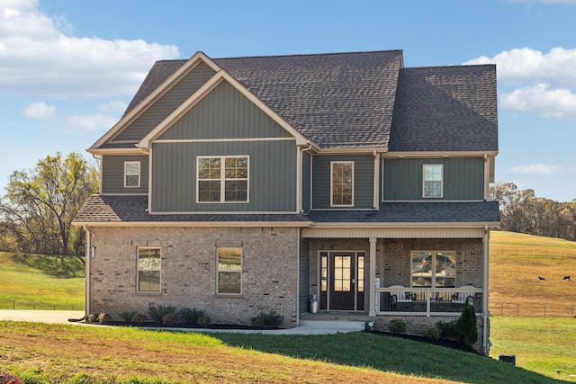 view of front of property with a porch and a front yard