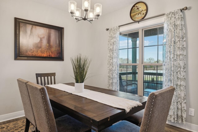 dining space with a chandelier and dark hardwood / wood-style floors