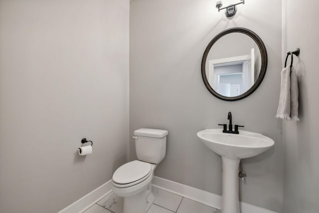 bathroom with tile patterned flooring and toilet