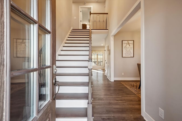 stairway with hardwood / wood-style floors