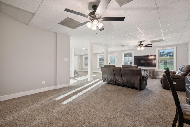 carpeted living room with a paneled ceiling, ceiling fan, and plenty of natural light