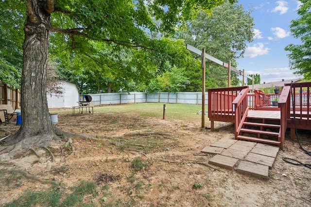 view of yard with a storage shed and a deck