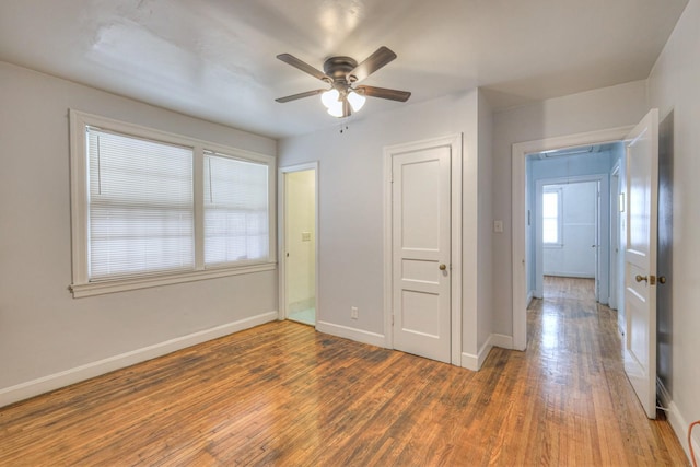 empty room with ceiling fan and dark wood-type flooring