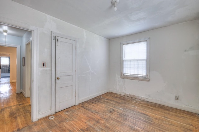 spare room with hardwood / wood-style floors