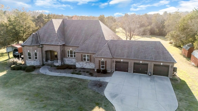 view of front of house with a garage and a front lawn