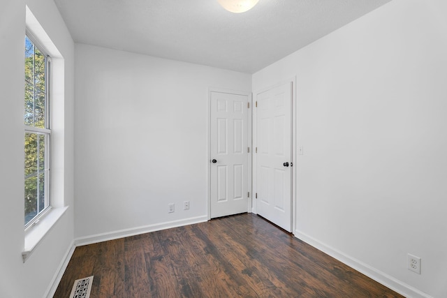 unfurnished room featuring dark hardwood / wood-style floors