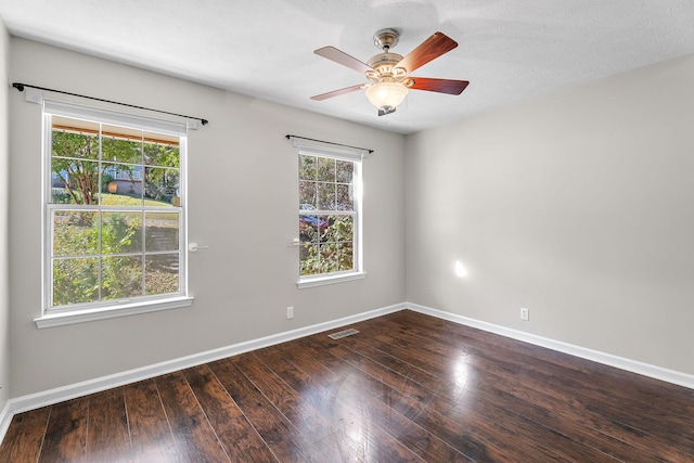 unfurnished room featuring a textured ceiling, ceiling fan, and dark wood-type flooring