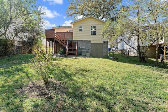 back of property featuring a lawn and a deck