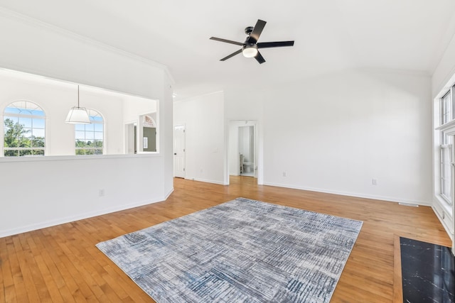 living room with ceiling fan, light wood-type flooring, and crown molding