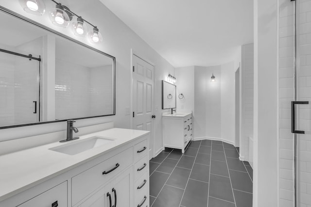 bathroom with tile patterned flooring, vanity, and a shower with door