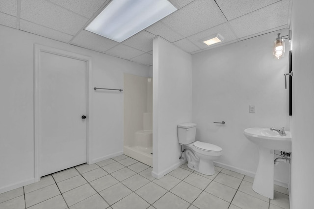 bathroom featuring tile patterned floors, a paneled ceiling, toilet, and walk in shower