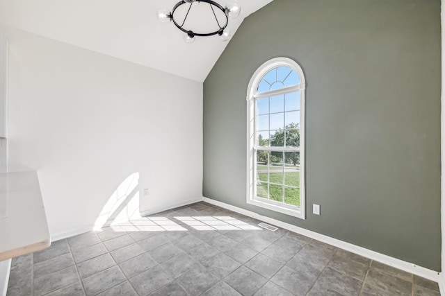 unfurnished dining area featuring tile patterned flooring, a healthy amount of sunlight, vaulted ceiling, and a notable chandelier