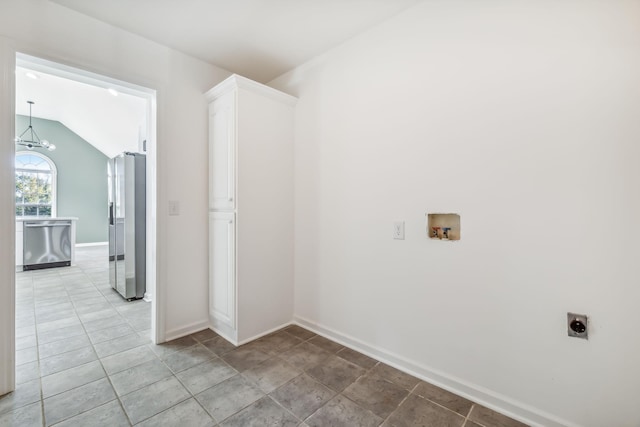 clothes washing area featuring cabinets, hookup for a washing machine, a chandelier, and hookup for an electric dryer