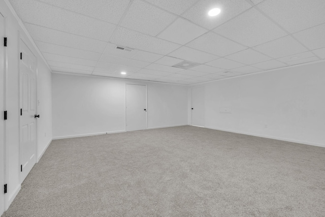 carpeted spare room featuring a paneled ceiling