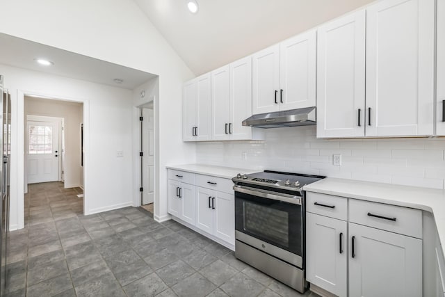 kitchen featuring decorative backsplash, vaulted ceiling, white cabinetry, and stainless steel electric range oven