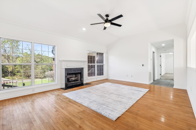 unfurnished living room featuring ceiling fan, lofted ceiling, and light hardwood / wood-style flooring