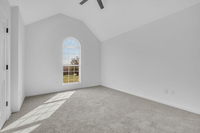 carpeted spare room with ceiling fan and lofted ceiling