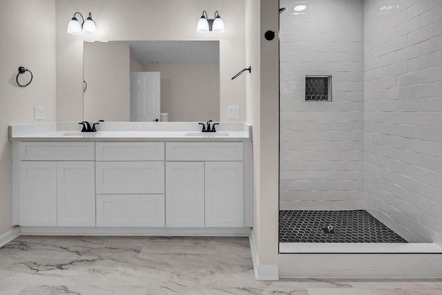 bathroom featuring vanity and a tile shower