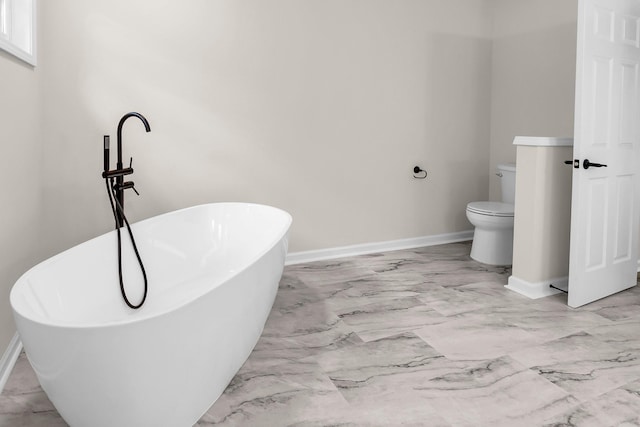 bathroom featuring a washtub and toilet