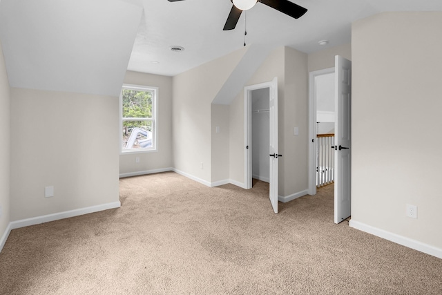 additional living space with ceiling fan, light carpet, and vaulted ceiling