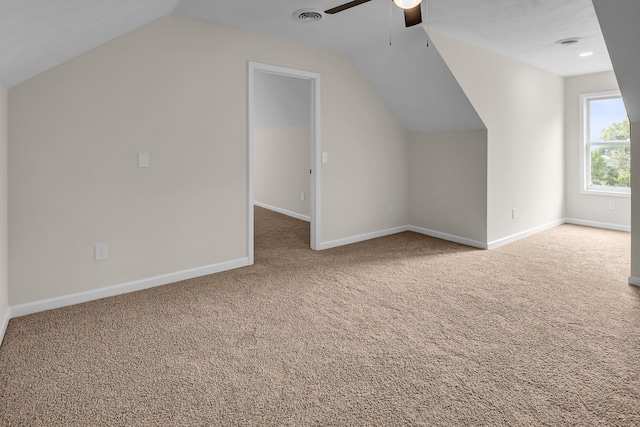 additional living space with ceiling fan, lofted ceiling, and carpet floors