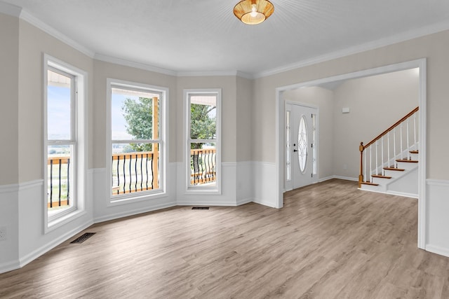 interior space with light hardwood / wood-style flooring and crown molding