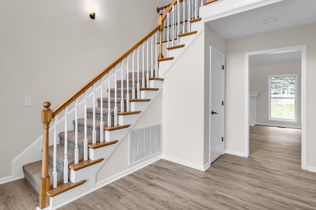 staircase with wood-type flooring