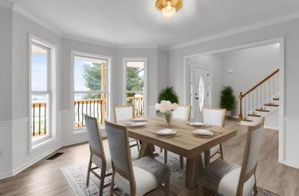 dining area featuring light hardwood / wood-style flooring and ornamental molding