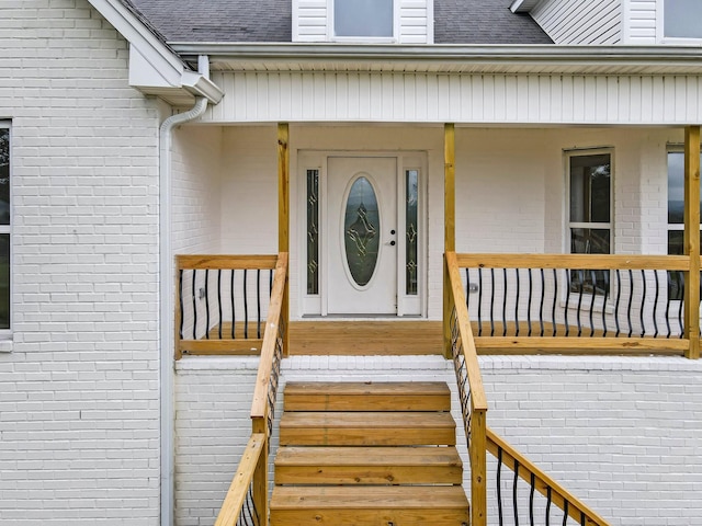 view of exterior entry with covered porch