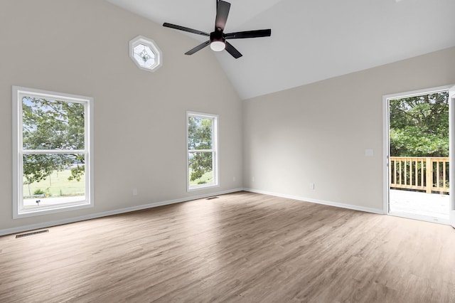 unfurnished living room featuring light wood-type flooring, high vaulted ceiling, and ceiling fan